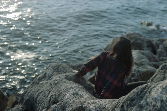 Jenna descending the rocks to the ocean