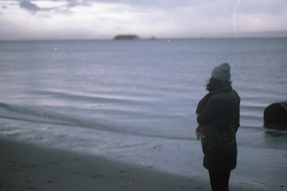 Ale standing on the beach looking at the ocean