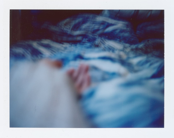 Polaroid self portrait of my arm in bed